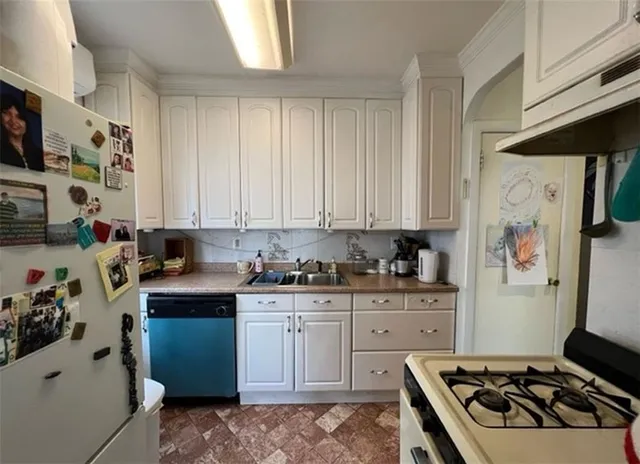 a kitchen with stainless steel appliances a stove a sink and a refrigerator
