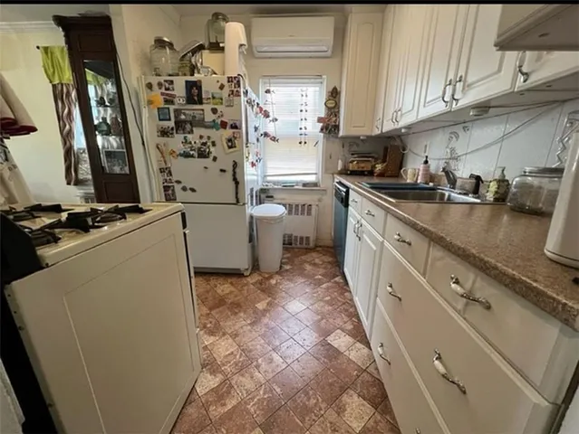 a kitchen with refrigerator and cabinets