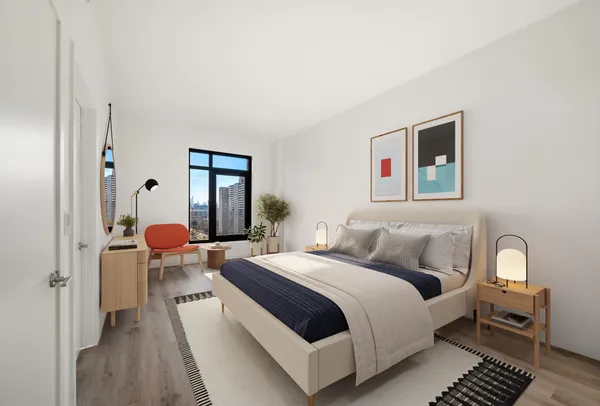 a bedroom with a bed and wooden floor