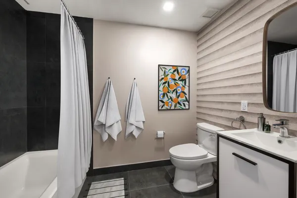 a bathroom with a toilet a sink and bathtub
