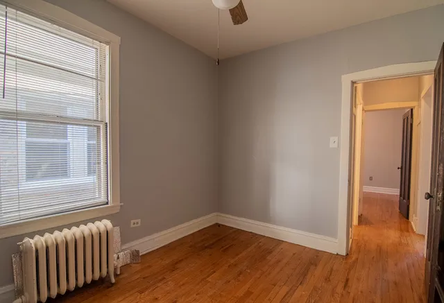 an empty room with windows and entrance