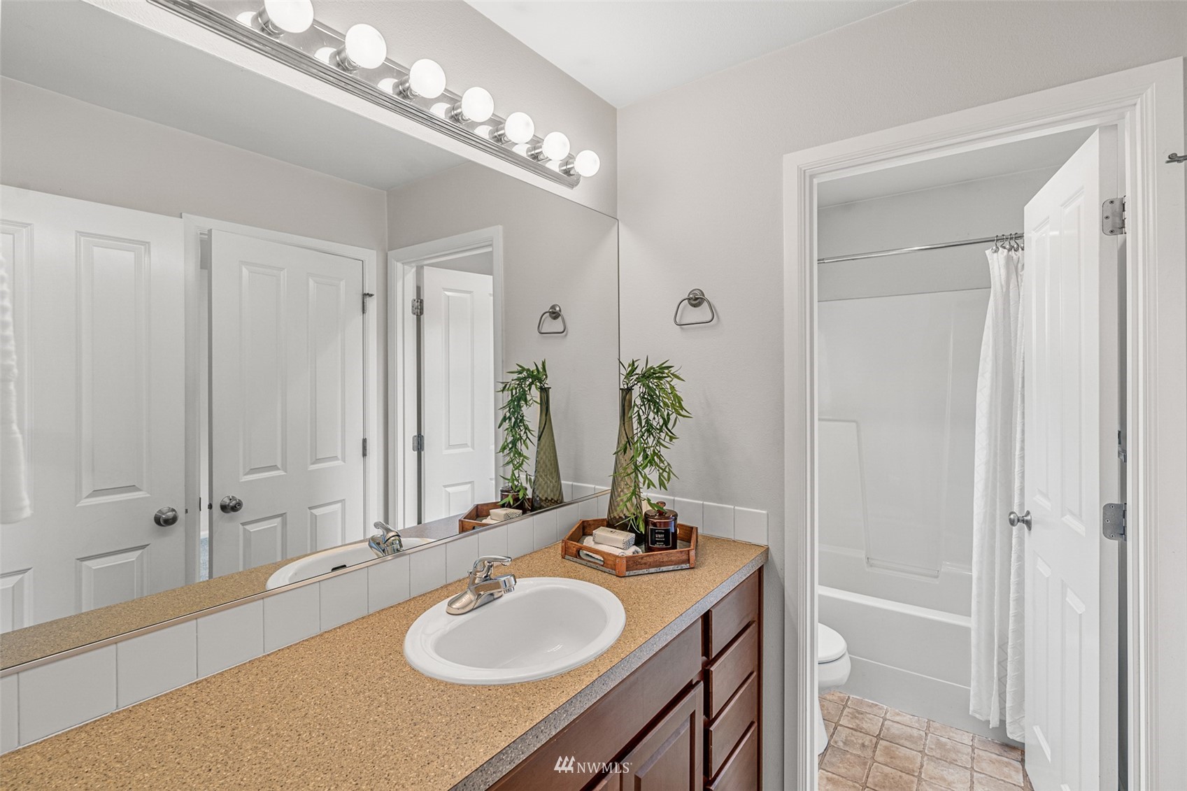 3509 160th Place Southeast Bothell, WA 98012 - Photo 21 of 31 a bathroom with a granite countertop sink and a mirror
