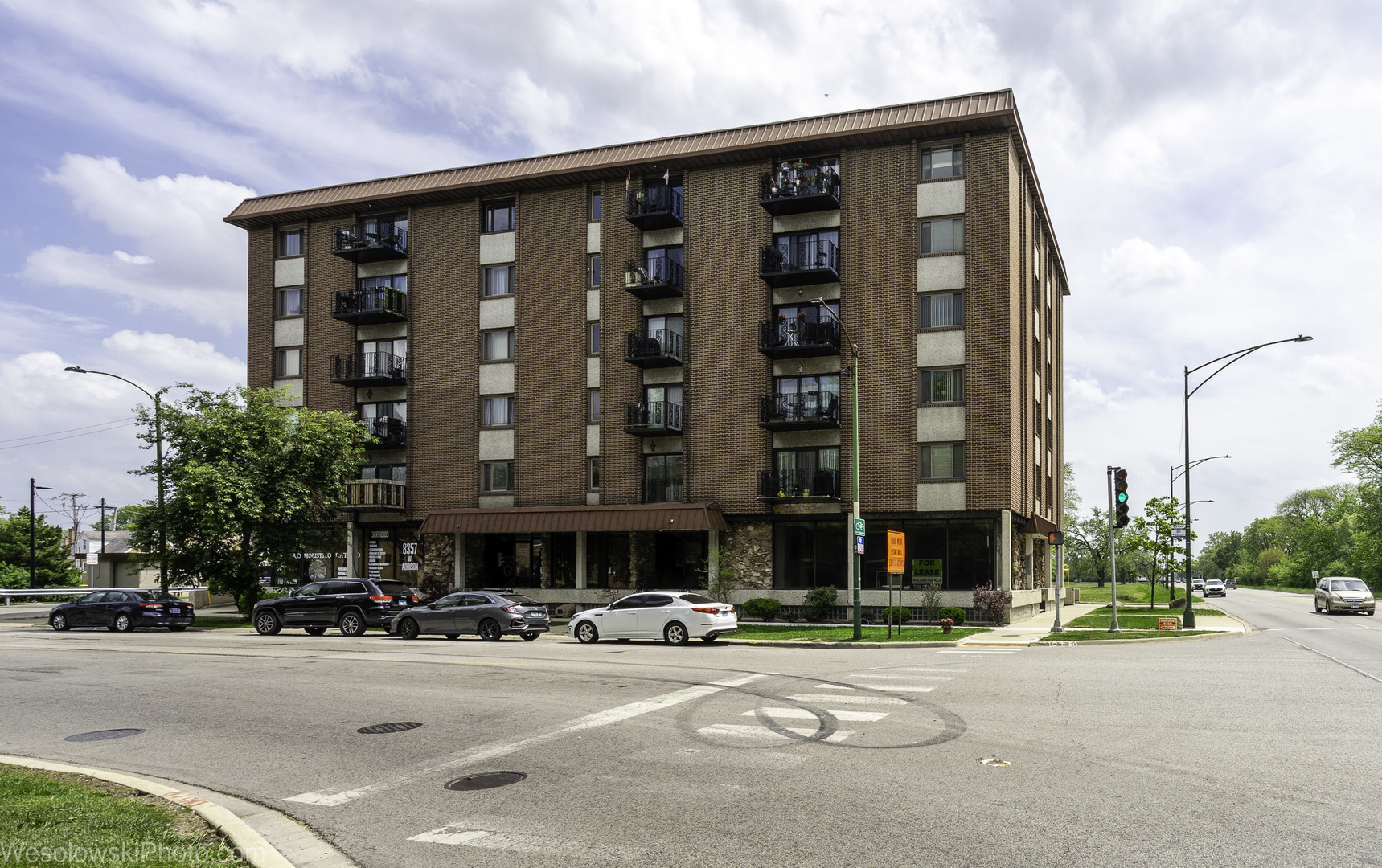 a front view of building with cars parked