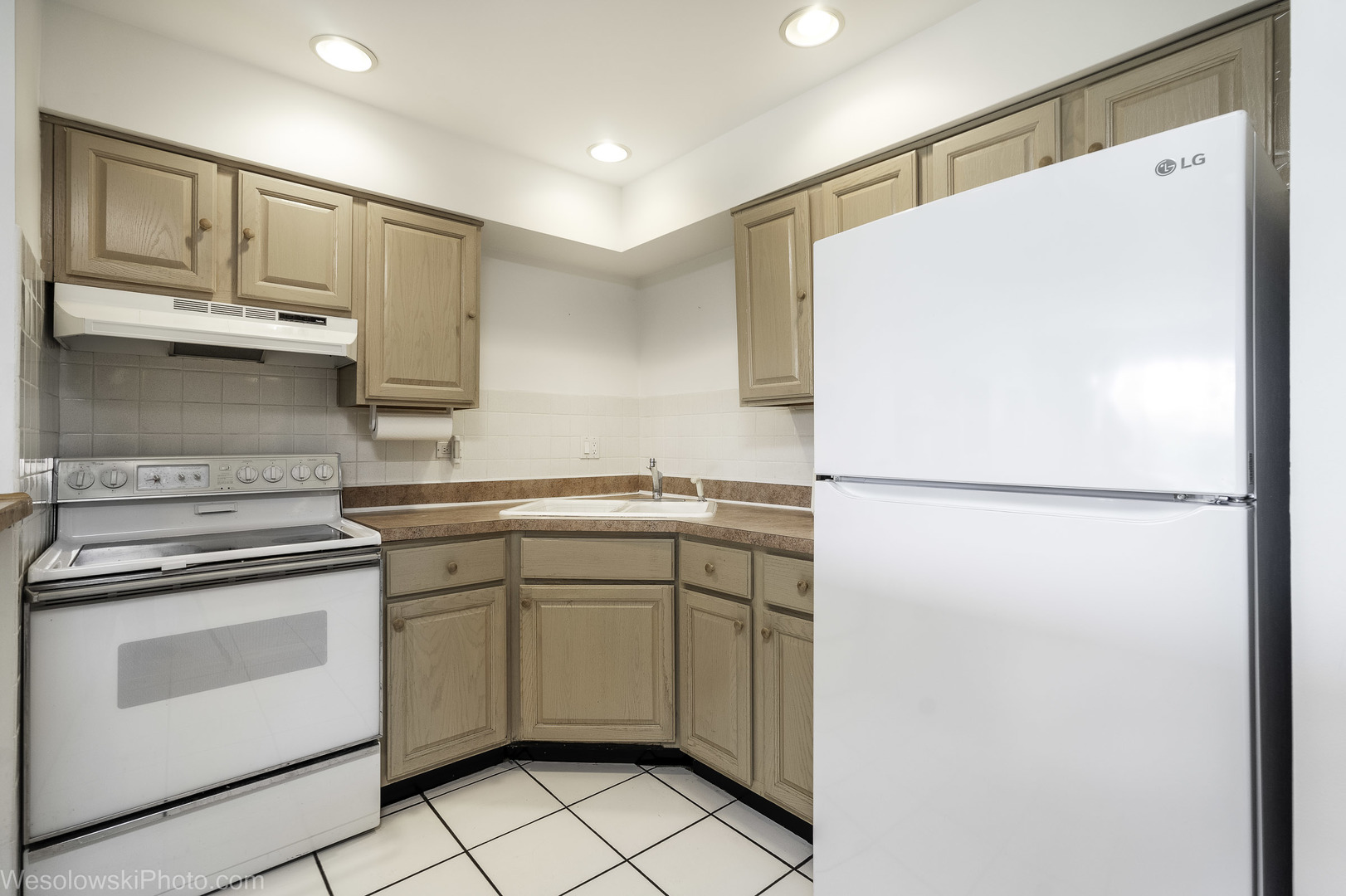 8359 West Addison Street, Unit 503 Chicago, IL 60634 - Photo 10 of 19 a kitchen with white cabinets and white appliances