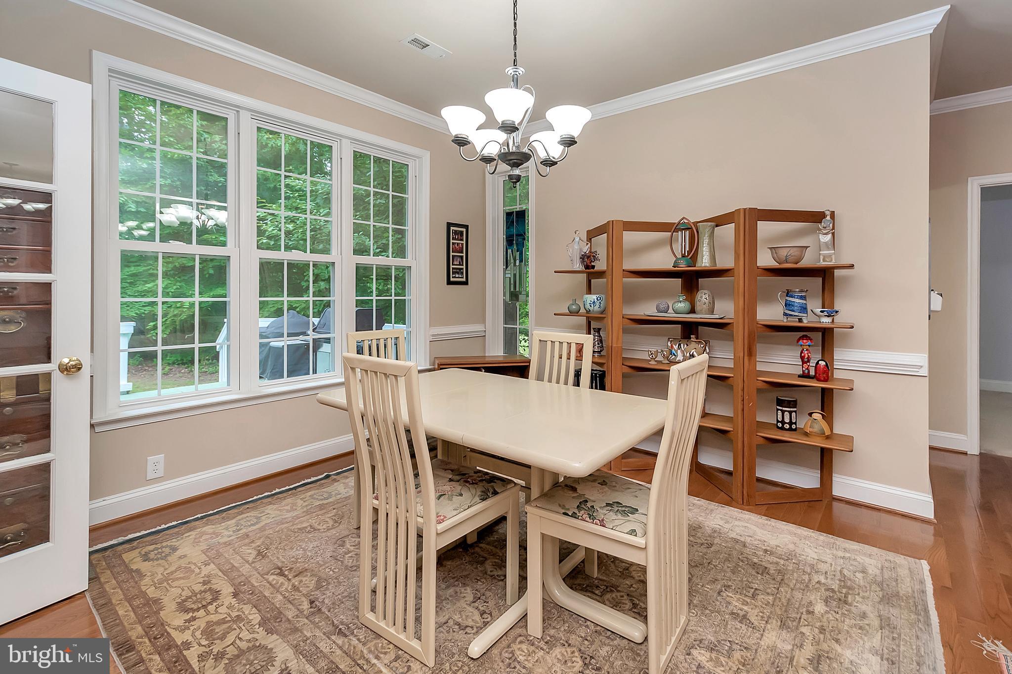 102 Birdie Road Locust Grove, VA 22508 - Photo 11 of 35 a view of a dining room with furniture and a chandelier