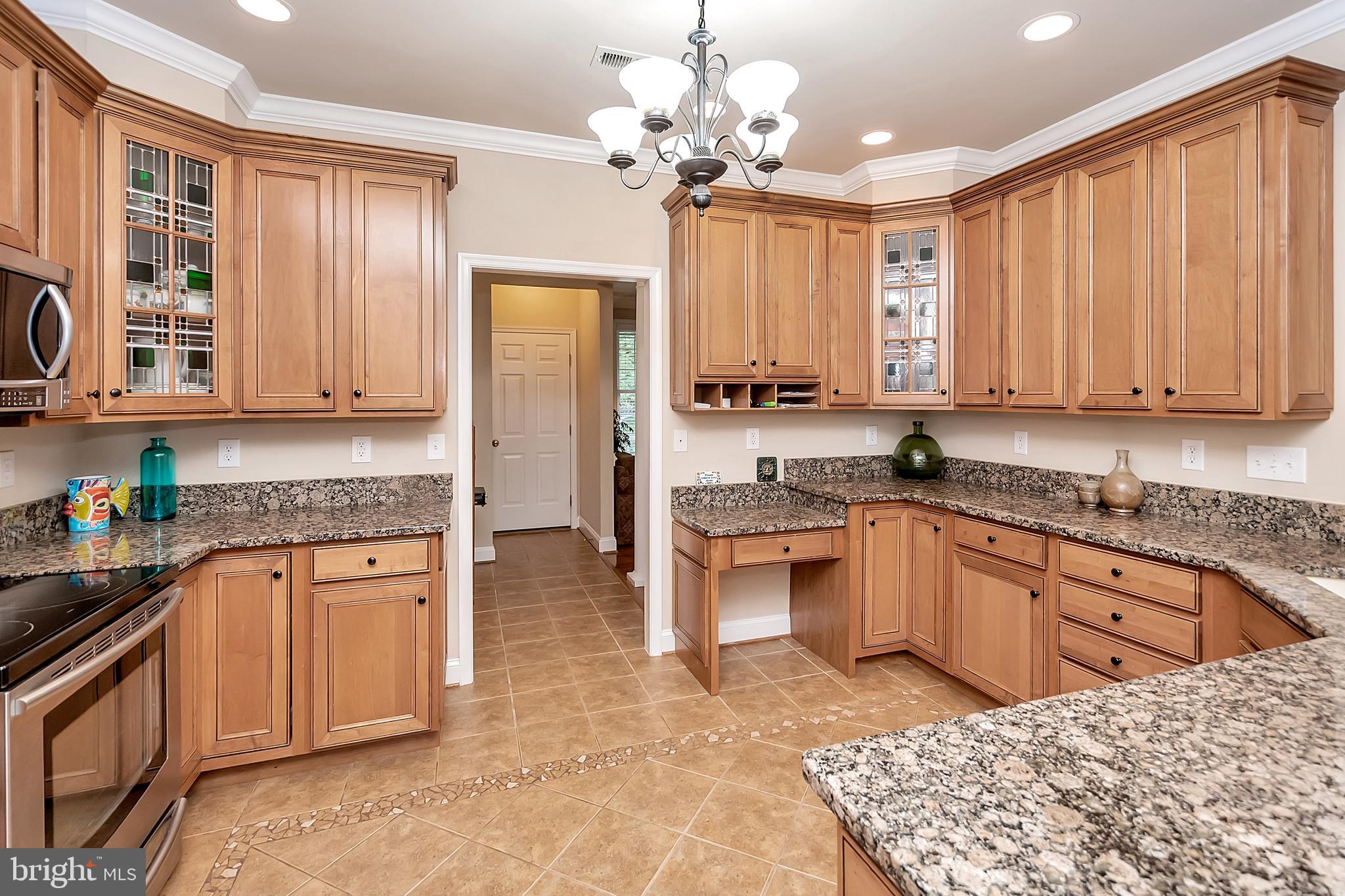 102 Birdie Road Locust Grove, VA 22508 - Photo 13 of 35 a kitchen with stainless steel appliances granite countertop a stove top oven a sink dishwasher and cabinets with wooden floor