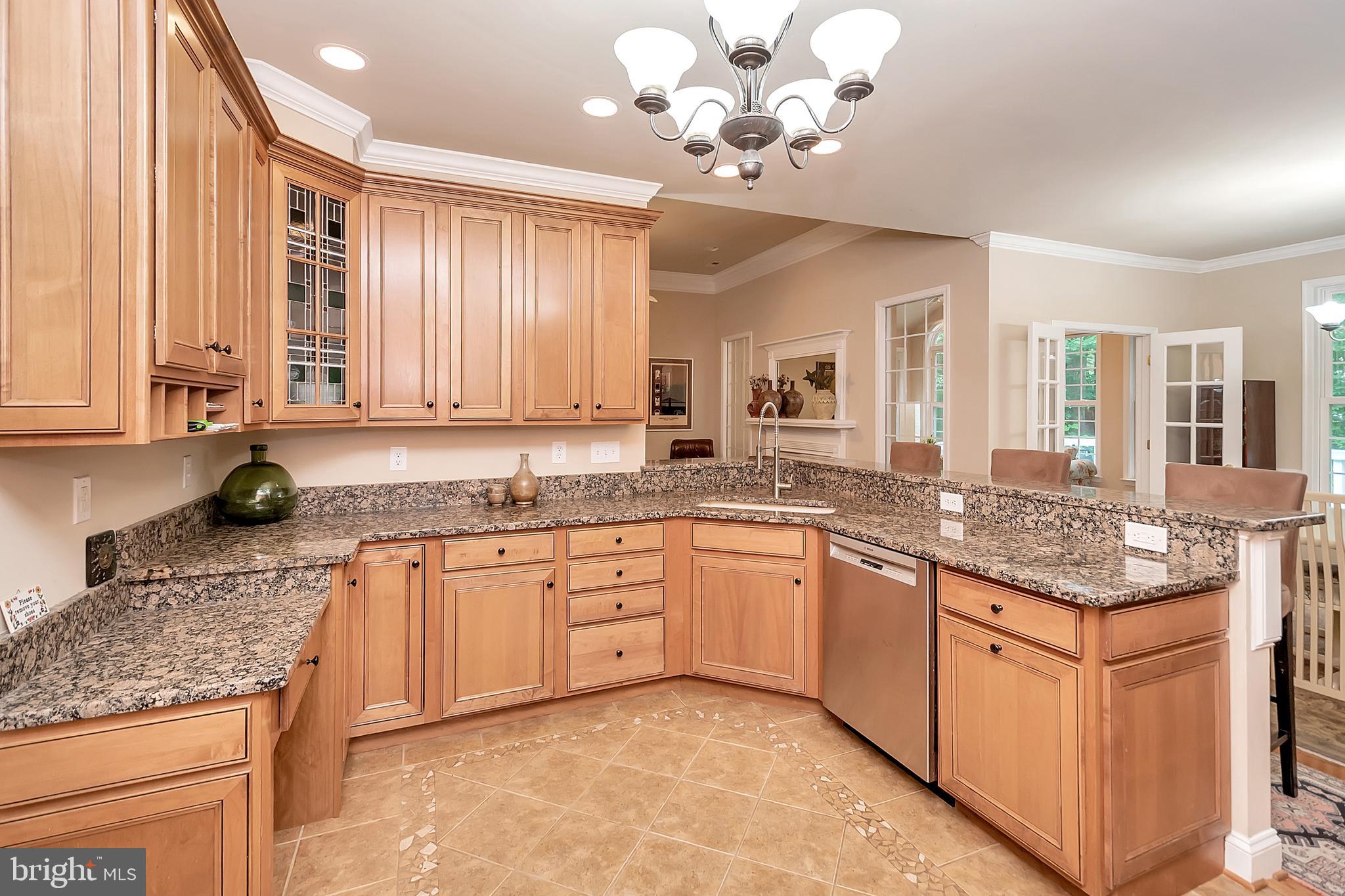 102 Birdie Road Locust Grove, VA 22508 - Photo 14 of 35 a large kitchen with kitchen island granite countertop a sink and dishwasher a stove top oven with wooden floor
