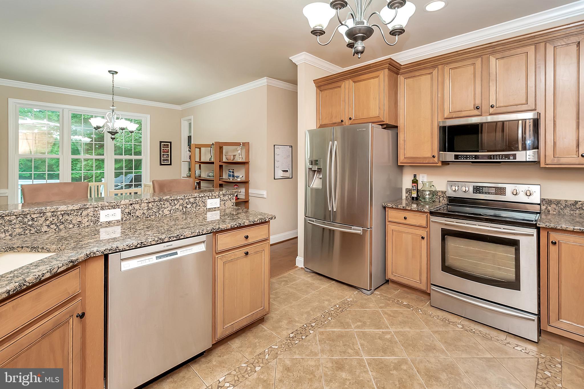 102 Birdie Road Locust Grove, VA 22508 - Photo 16 of 35 a kitchen with stainless steel appliances granite countertop a refrigerator stove microwave and sink