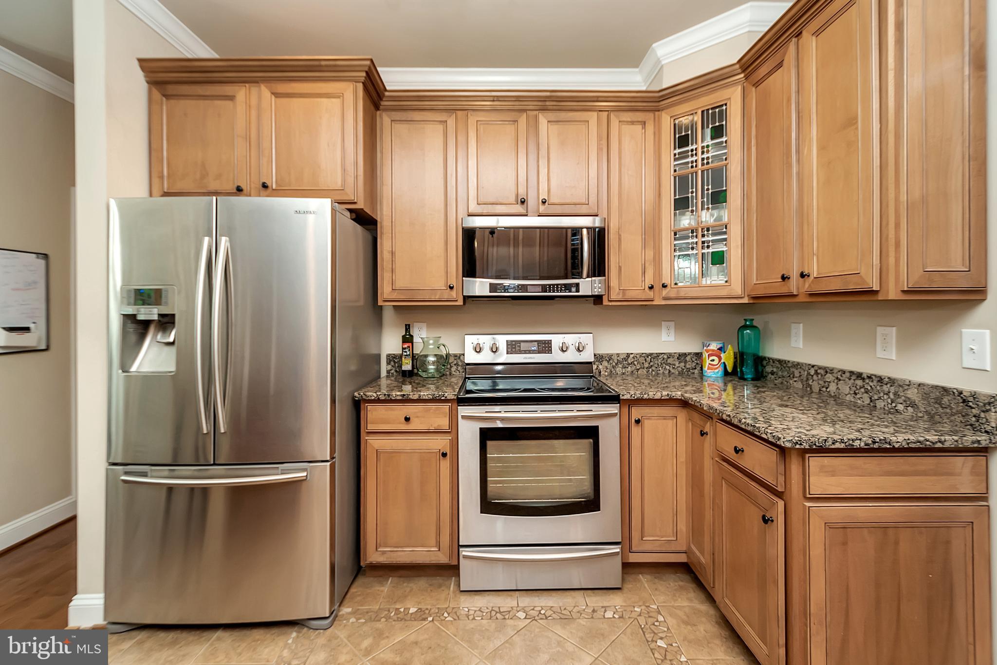 102 Birdie Road Locust Grove, VA 22508 - Photo 17 of 35 a kitchen with granite countertop a refrigerator stove and microwave
