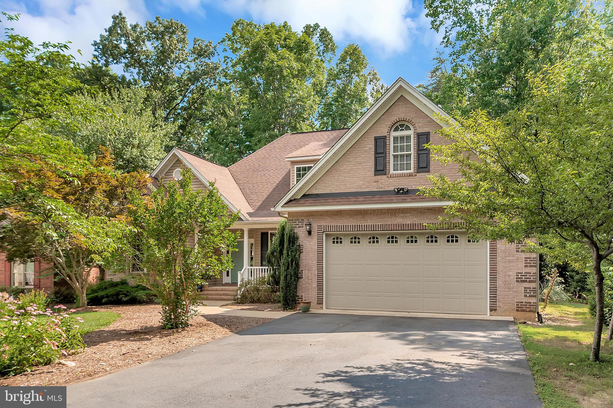 102 Birdie Road Locust Grove, VA 22508 - Photo 3 of 35 a front view of a house with a yard and garage