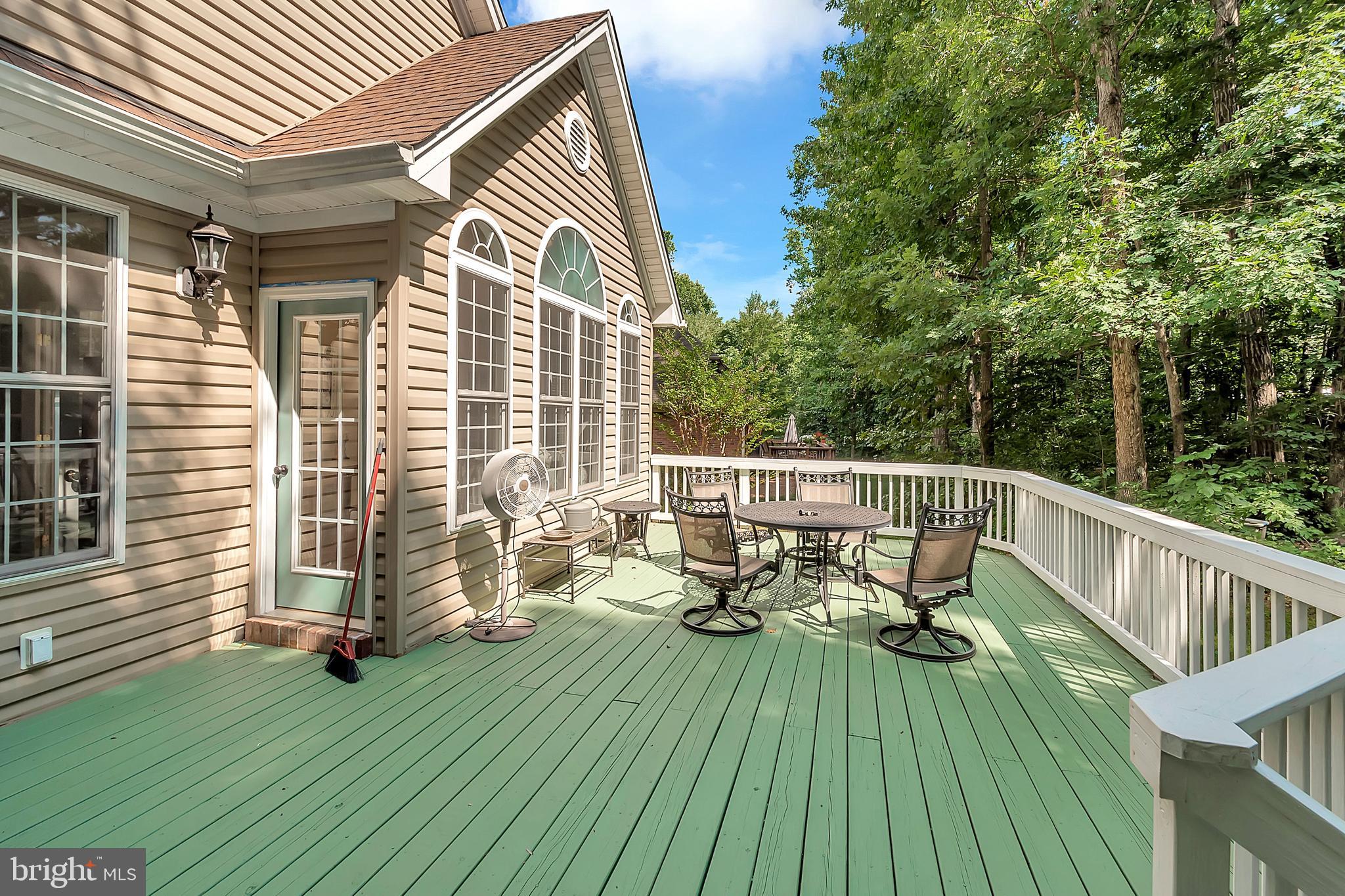 102 Birdie Road Locust Grove, VA 22508 - Photo 25 of 35 a view of deck with a table and chairs and wooden floor