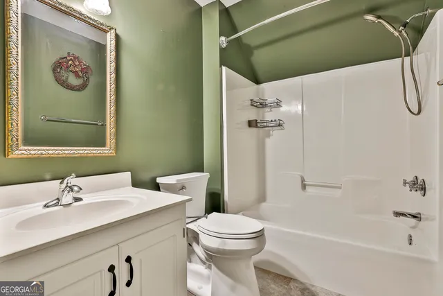 an empty room with windows and a chandelier fan