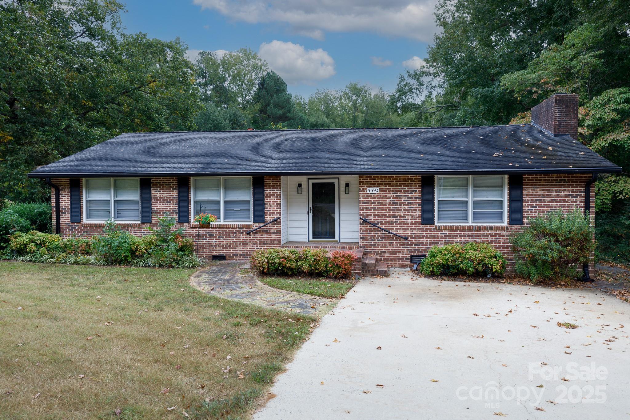 a front view of a house with a garden and plants