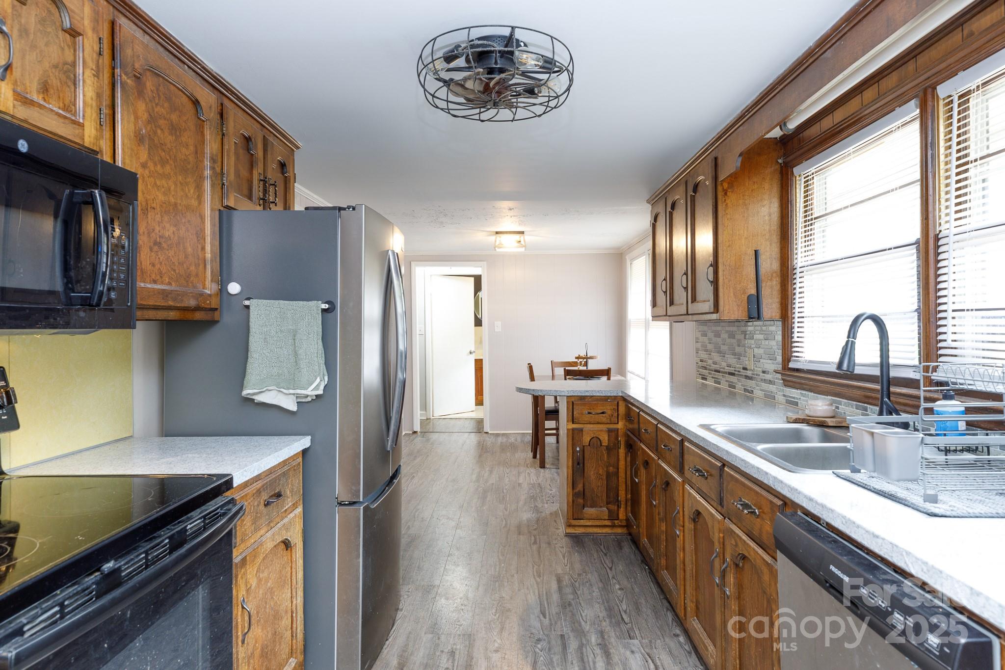3393 Mt Holly Road Edgemoor, SC 29712 - Photo 16 of 21 a kitchen with stainless steel appliances granite countertop a sink stove and refrigerator