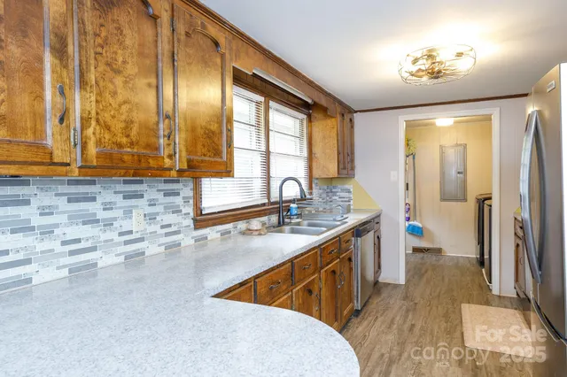 a kitchen with stainless steel appliances granite countertop a sink stove and cabinets