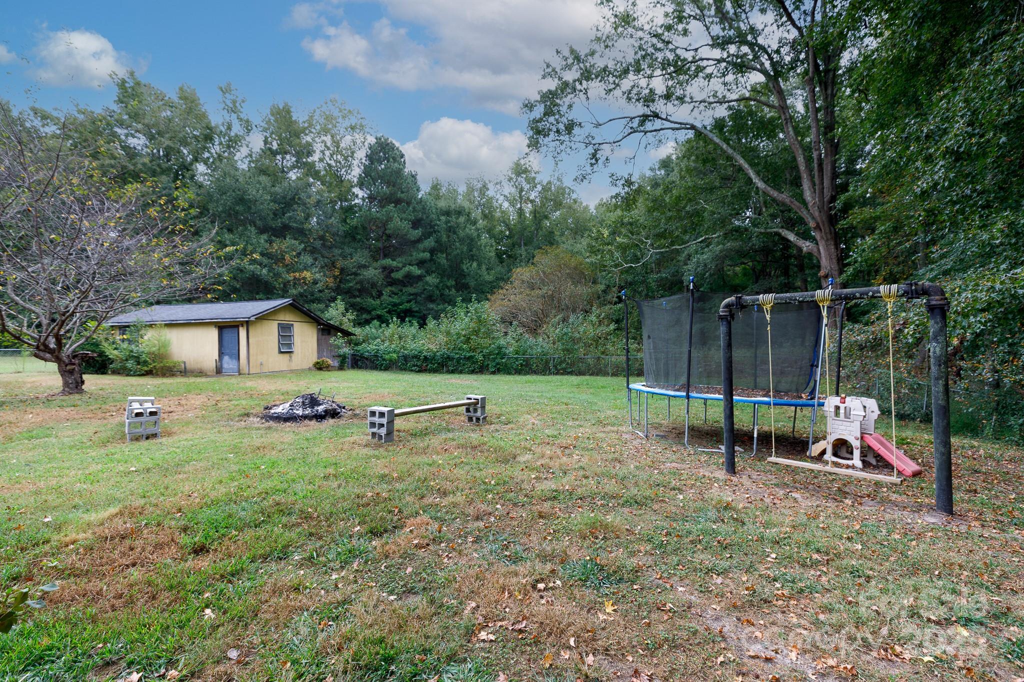 3393 Mt Holly Road Edgemoor, SC 29712 - Photo 19 of 21 a view of backyard with a slide and a bench
