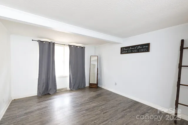 an empty room with wooden floor and closet