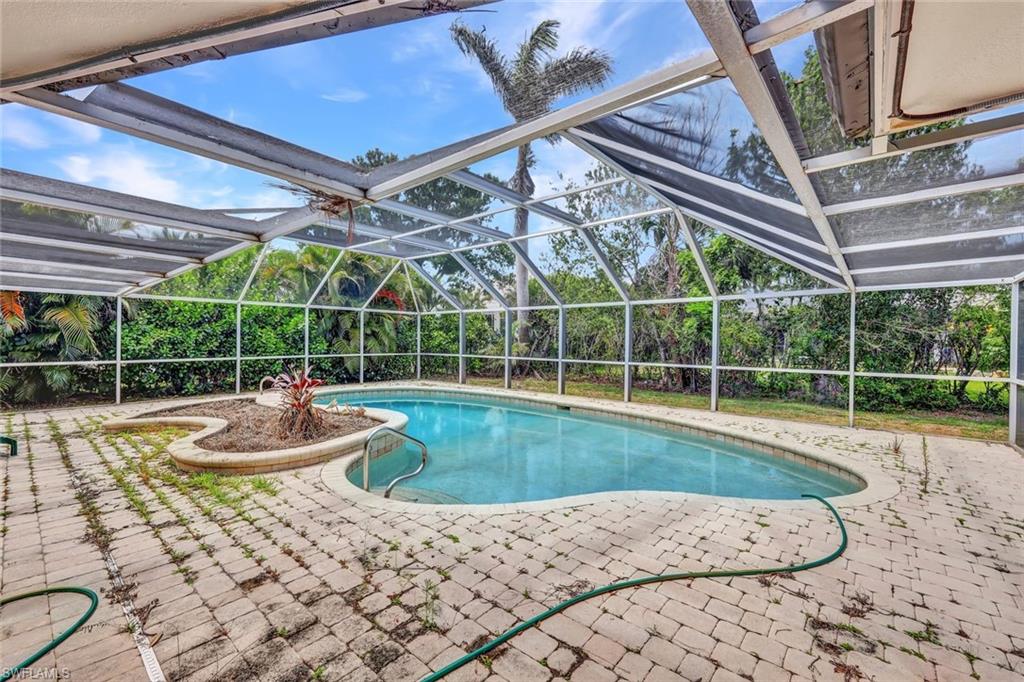 529 Neapolitan Way Naples, FL 34103 - Photo 4 of 18 a view of a backyard with a swimming pool