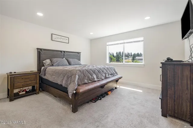 a bedroom with a bed and a television