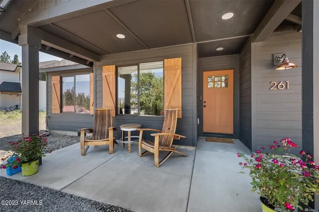 a living room with furniture and flowers