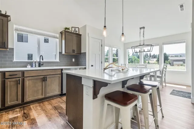 a kitchen with a sink cabinets and window
