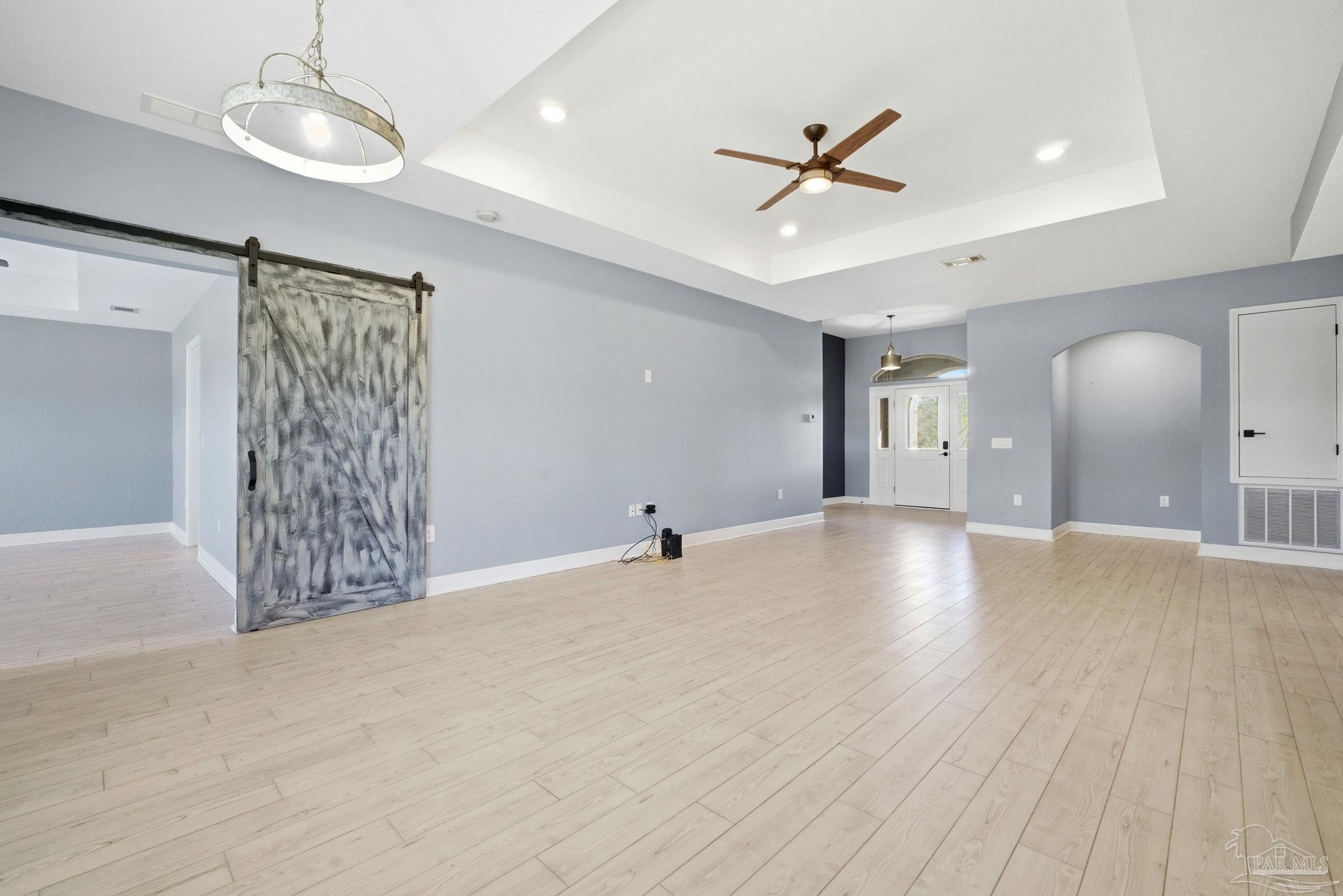 2033 Chavers Road Cantonment, FL 32533 - Photo 12 of 42 a view of an empty room with a ceiling fan and window