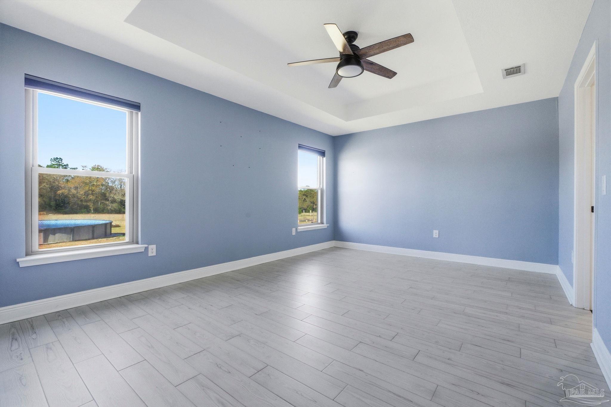2033 Chavers Road Cantonment, FL 32533 - Photo 13 of 42 a view of empty room with wooden floor and fan