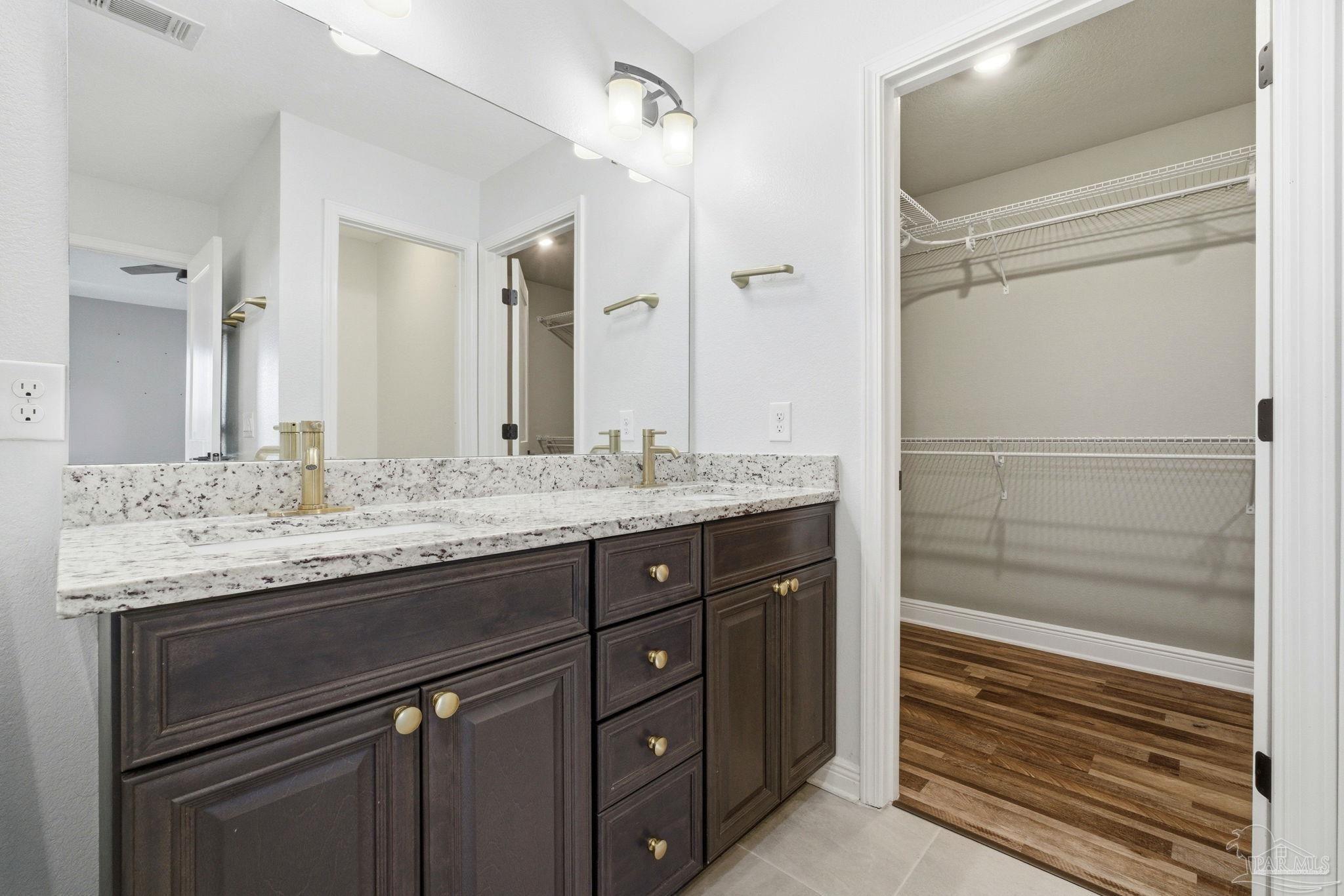 2033 Chavers Road Cantonment, FL 32533 - Photo 15 of 42 a bathroom with a granite countertop sink and a mirror