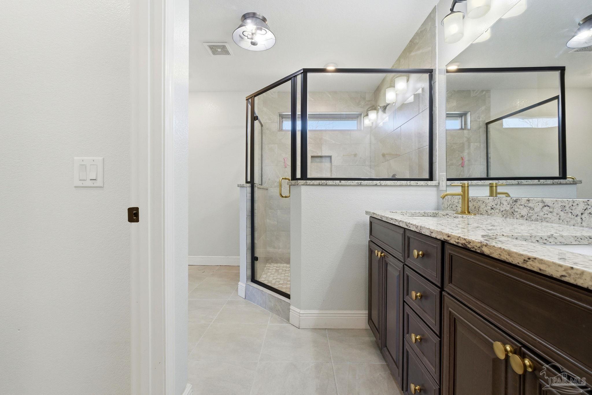 2033 Chavers Road Cantonment, FL 32533 - Photo 16 of 42 a bathroom with a granite countertop sink mirror and vanity