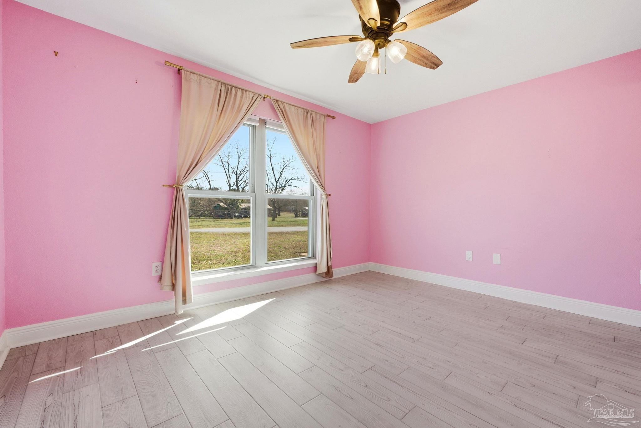 2033 Chavers Road Cantonment, FL 32533 - Photo 20 of 42 an empty room with windows and fan
