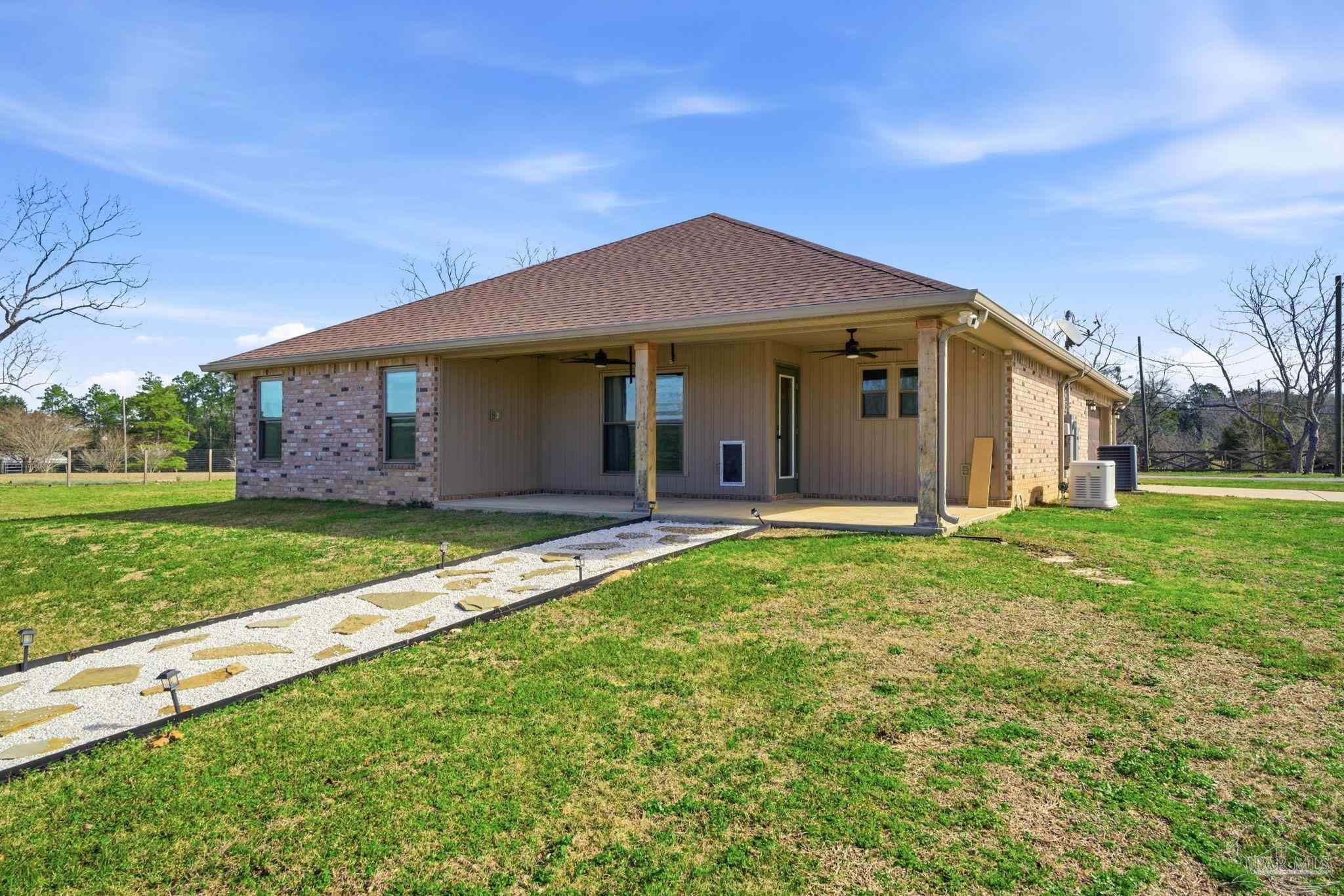 2033 Chavers Road Cantonment, FL 32533 - Photo 29 of 42 a front view of house with yard and green space