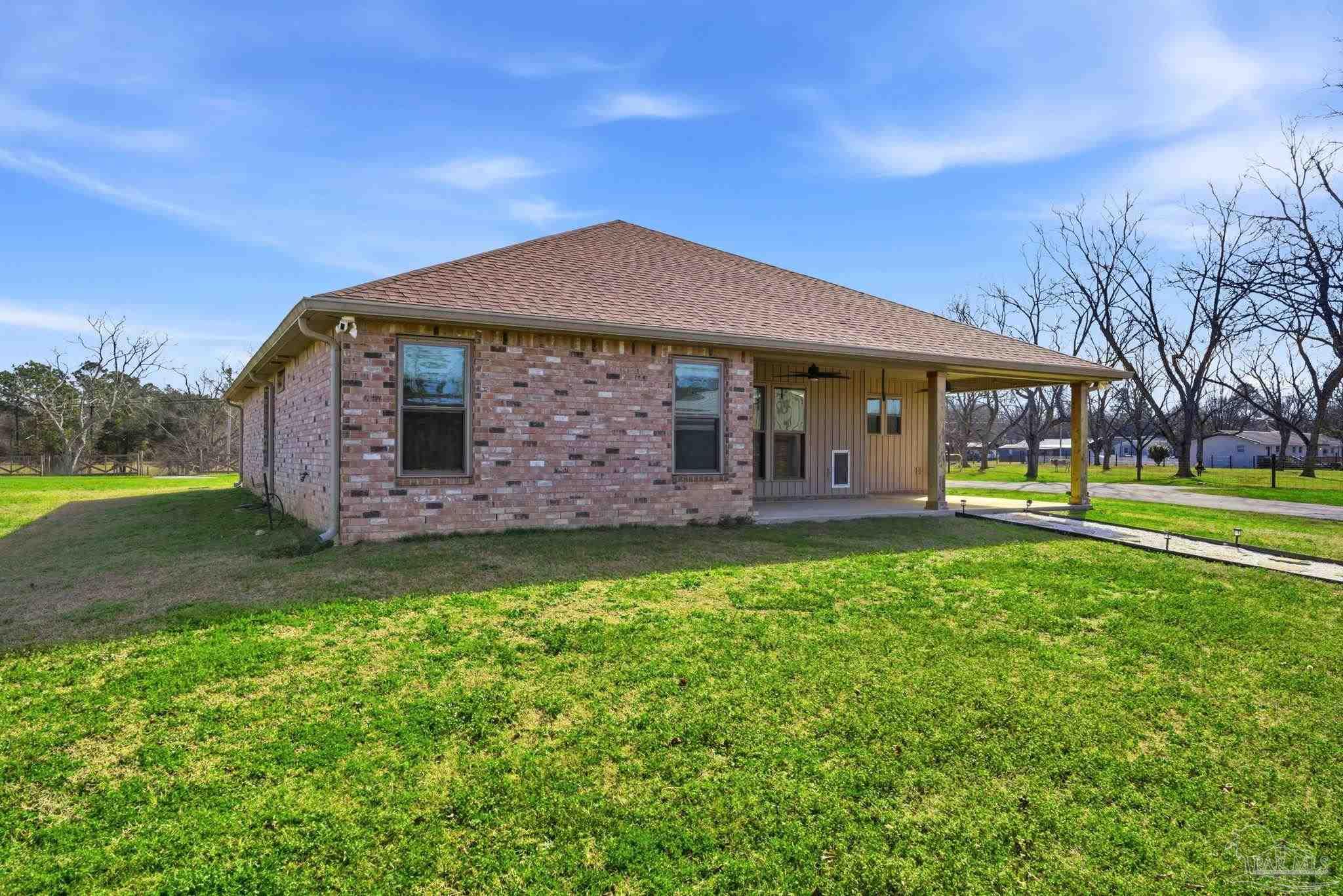 2033 Chavers Road Cantonment, FL 32533 - Photo 31 of 42 a front view of a house with garden