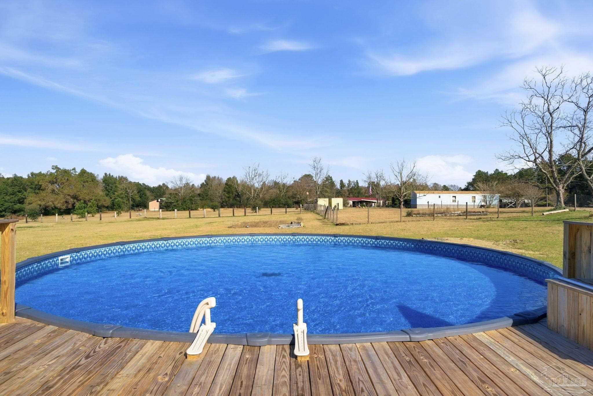 2033 Chavers Road Cantonment, FL 32533 - Photo 34 of 42 a view of a lake with houses in the background
