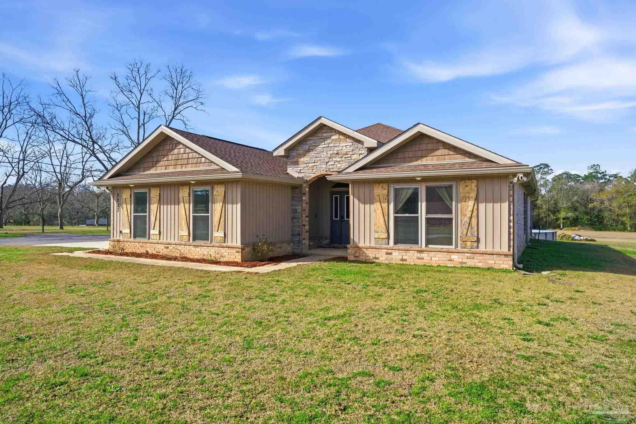 2033 Chavers Road Cantonment, FL 32533 - Photo 38 of 42 a front view of a house with a garden