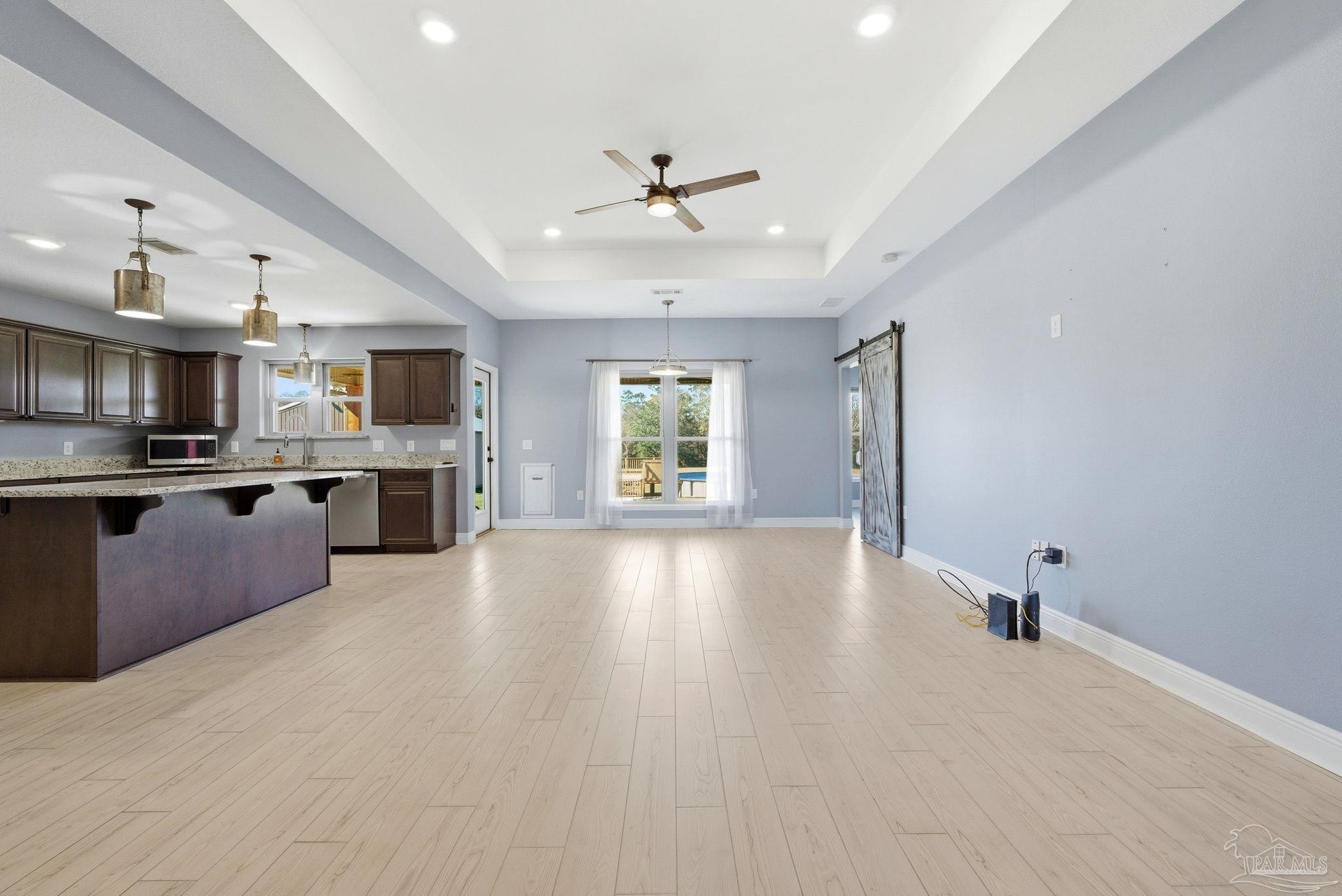 2033 Chavers Road Cantonment, FL 32533 - Photo 5 of 42 a view of kitchen and kitchen with sink wooden floor and window