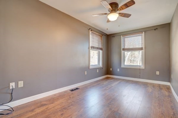 56 Old Belchertown Road Ware, MA 01082 - Photo 13 of 25 a view of an empty room with window and wooden floor