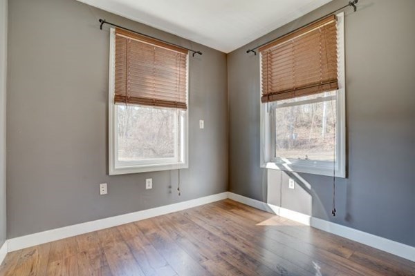 56 Old Belchertown Road Ware, MA 01082 - Photo 15 of 25 an empty room with wooden floor and windows