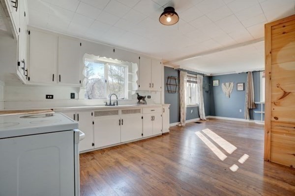 56 Old Belchertown Road Ware, MA 01082 - Photo 4 of 25 a kitchen with sink cabinets and wooden floor