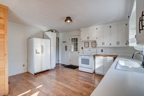 56 Old Belchertown Road Ware, MA 01082 - Photo 5 of 25 a kitchen with white cabinets and white appliances