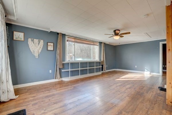 56 Old Belchertown Road Ware, MA 01082 - Photo 8 of 25 a view of empty room with wooden floor and fan
