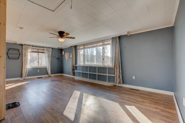 56 Old Belchertown Road Ware, MA 01082 - Photo 10 of 25 a view of an empty room with a window and wooden floor