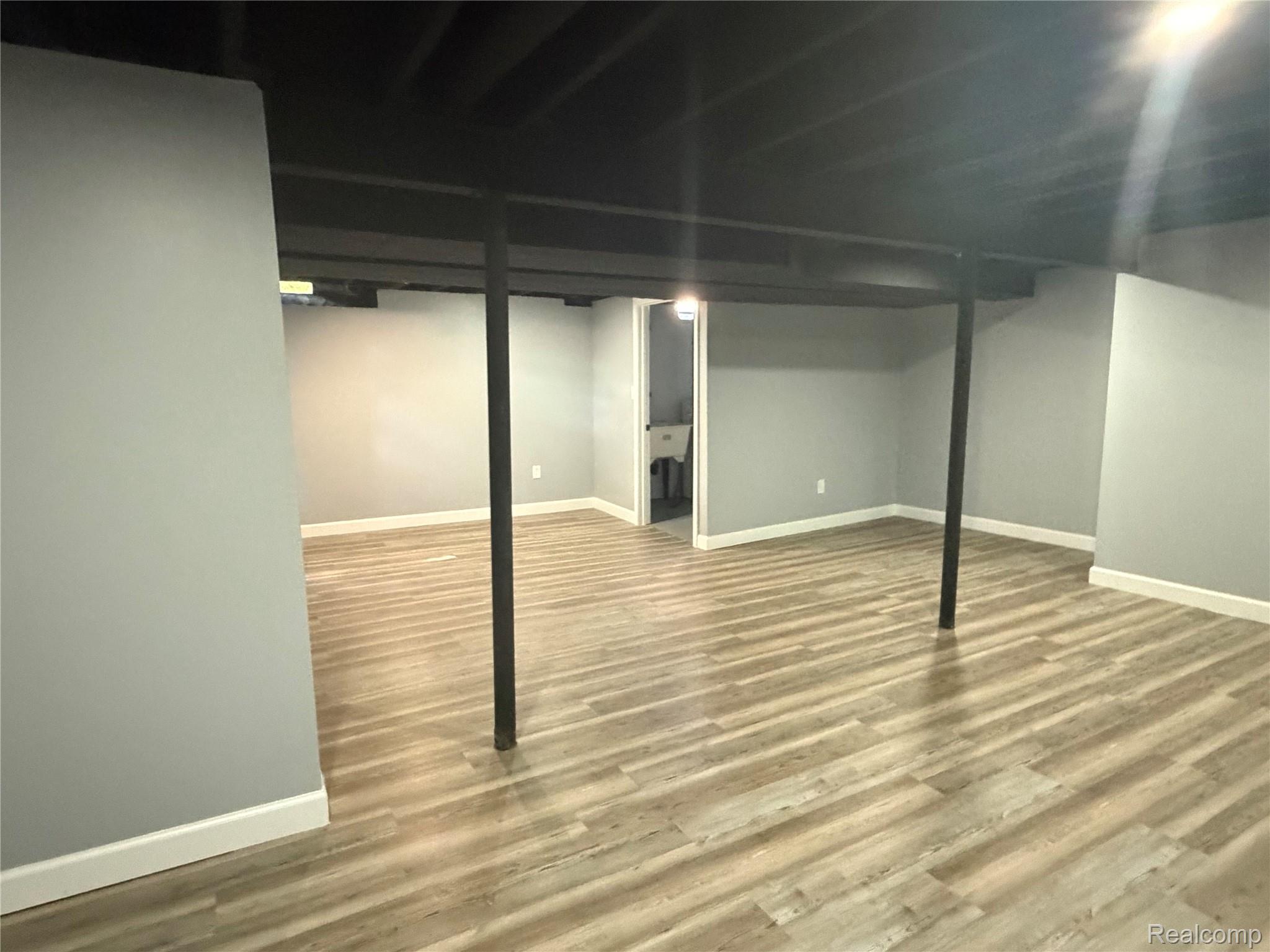 20698 Coachwood Road Riverview, MI 48193 - Photo 16 of 37 Finished below grade area with baseboards and wood finished floors