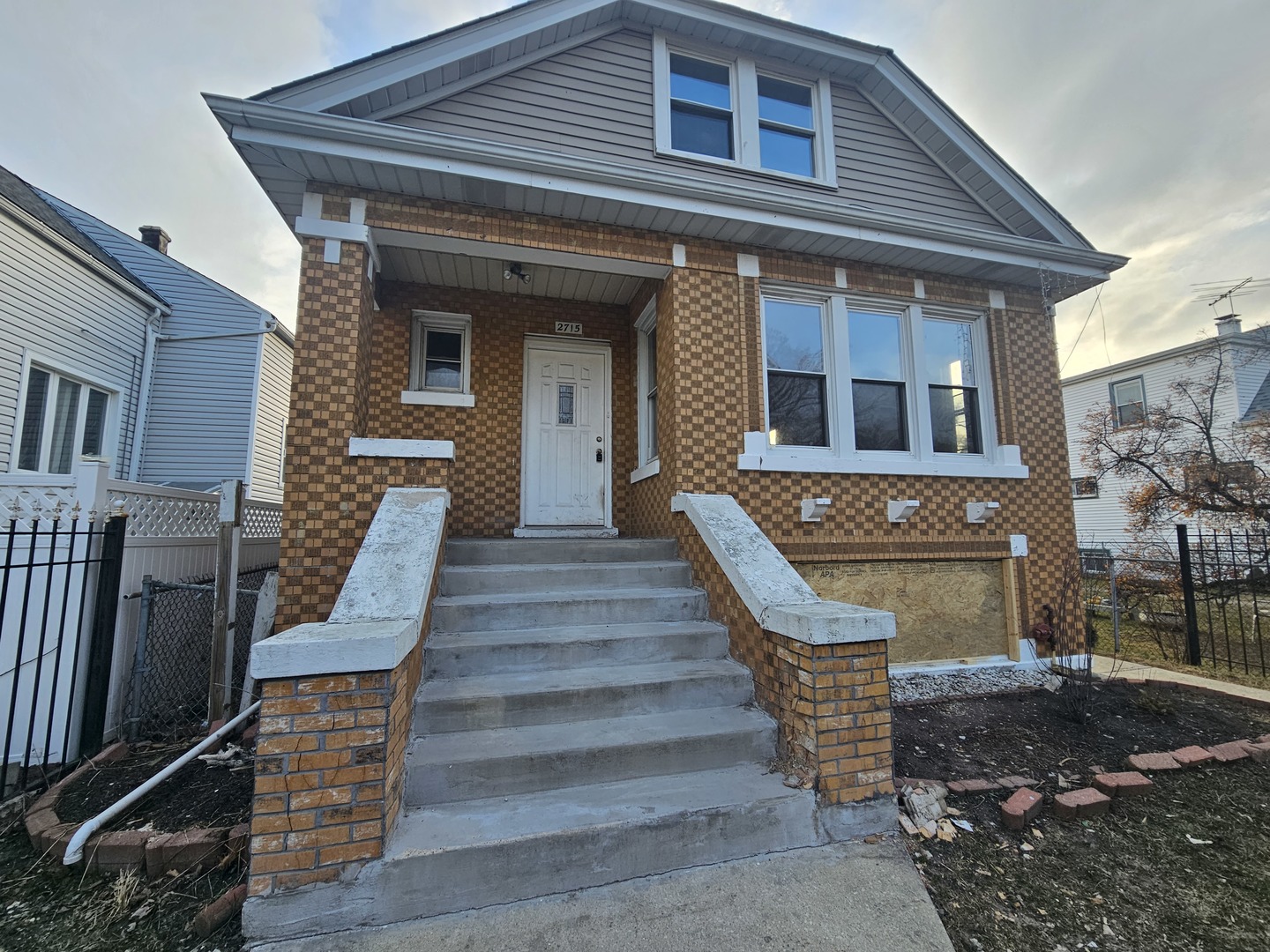 2715 North Monitor Avenue Chicago, IL 60639 - Photo 2 of 23 a front view of a house with wooden stairs