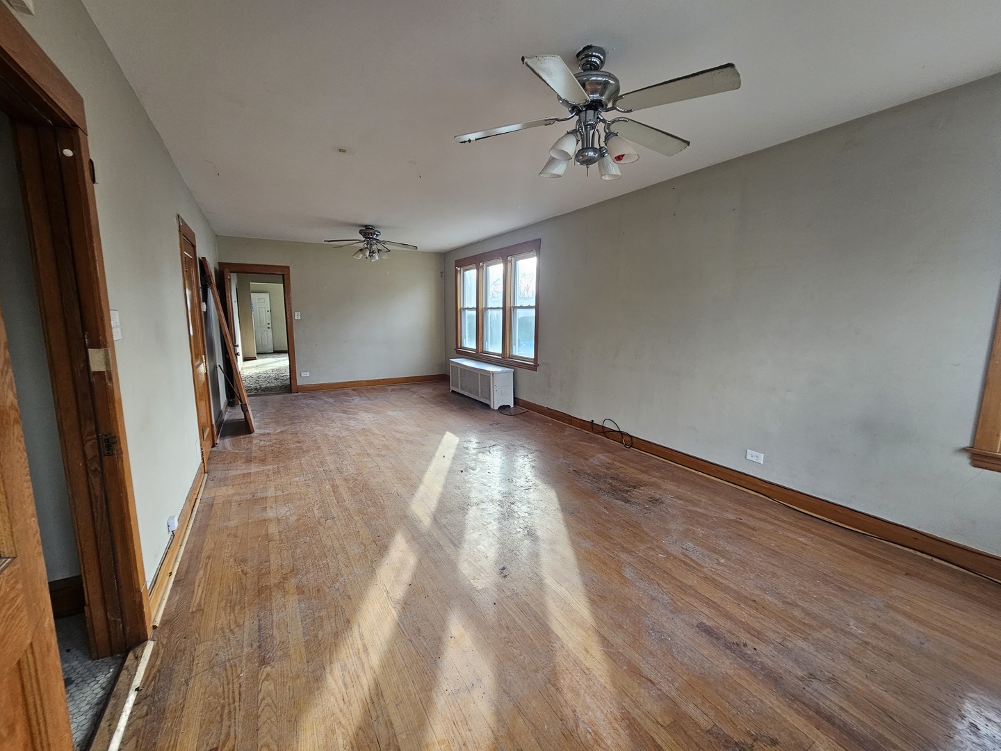 2715 North Monitor Avenue Chicago, IL 60639 - Photo 3 of 23 wooden floor in an empty room with a window