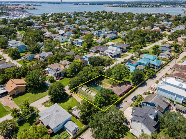 an aerial view of a residential houses with outdoor space