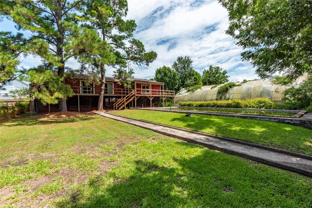 a view of a house with swimming pool and yard