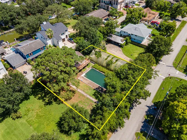 an aerial view of residential house with yard and swimming pool