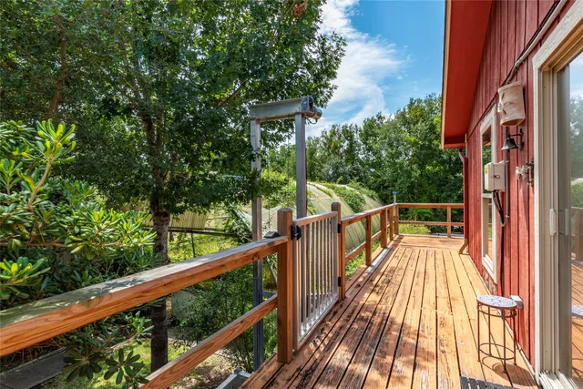 a view of balcony with wooden floor and fence