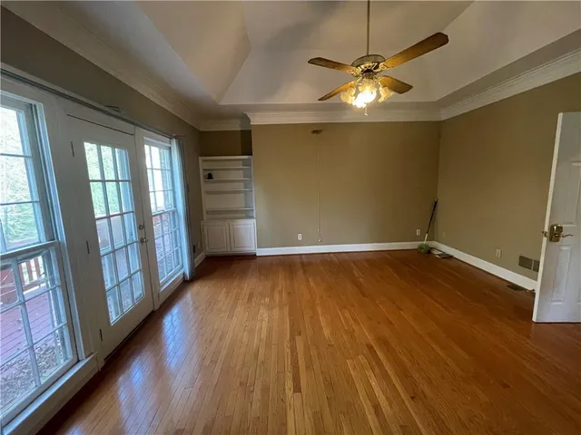 wooden floor in an empty room with a window