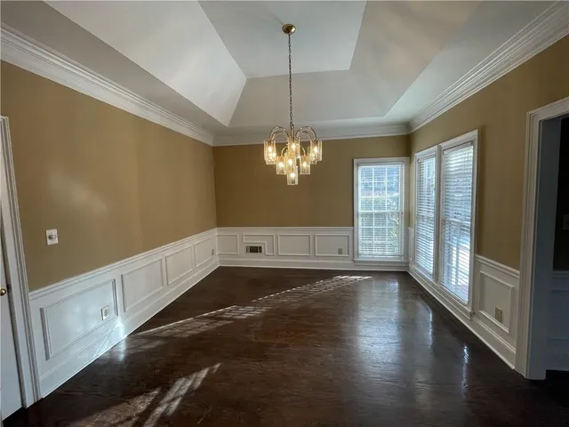 a view of a room with wooden floor and chandelier